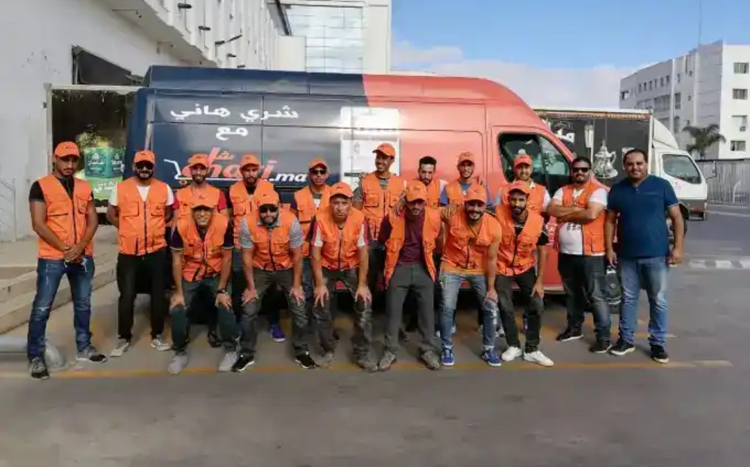 Chari team beside company van